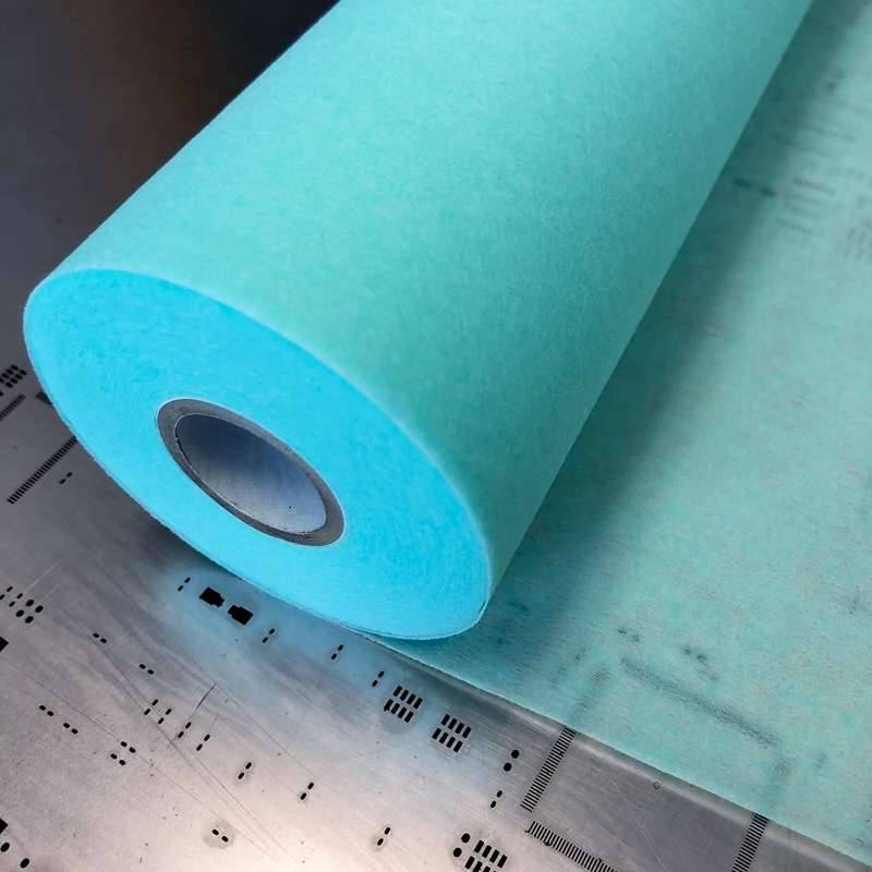 green roll of material sitting on metal stencil