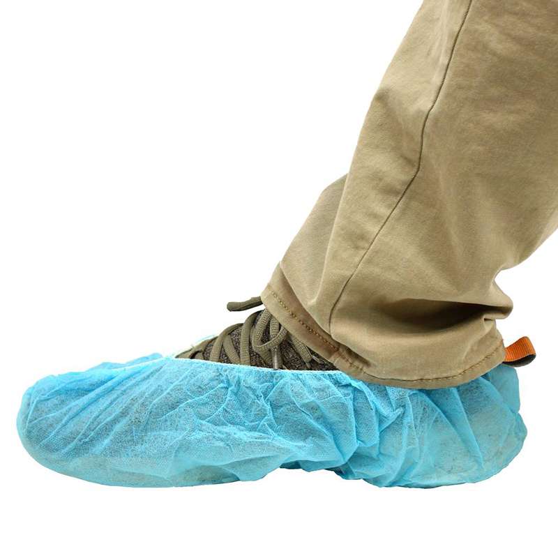 blue shoe cover over brown sneaker and partial leg